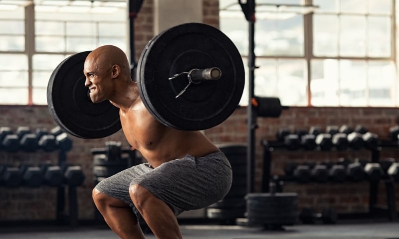 man lifting weights during squat