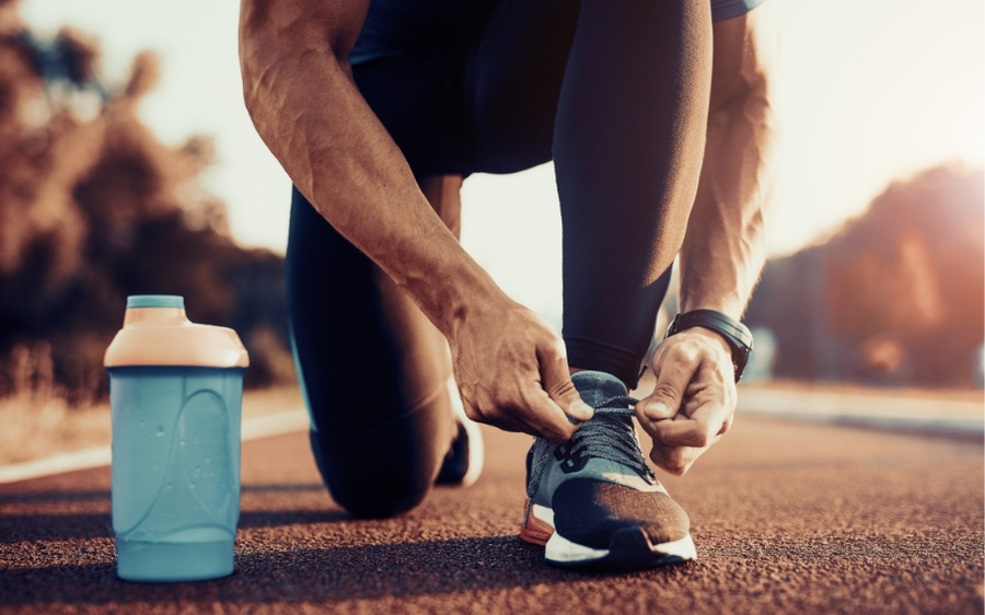 Image of a person tying running shoes before a workout