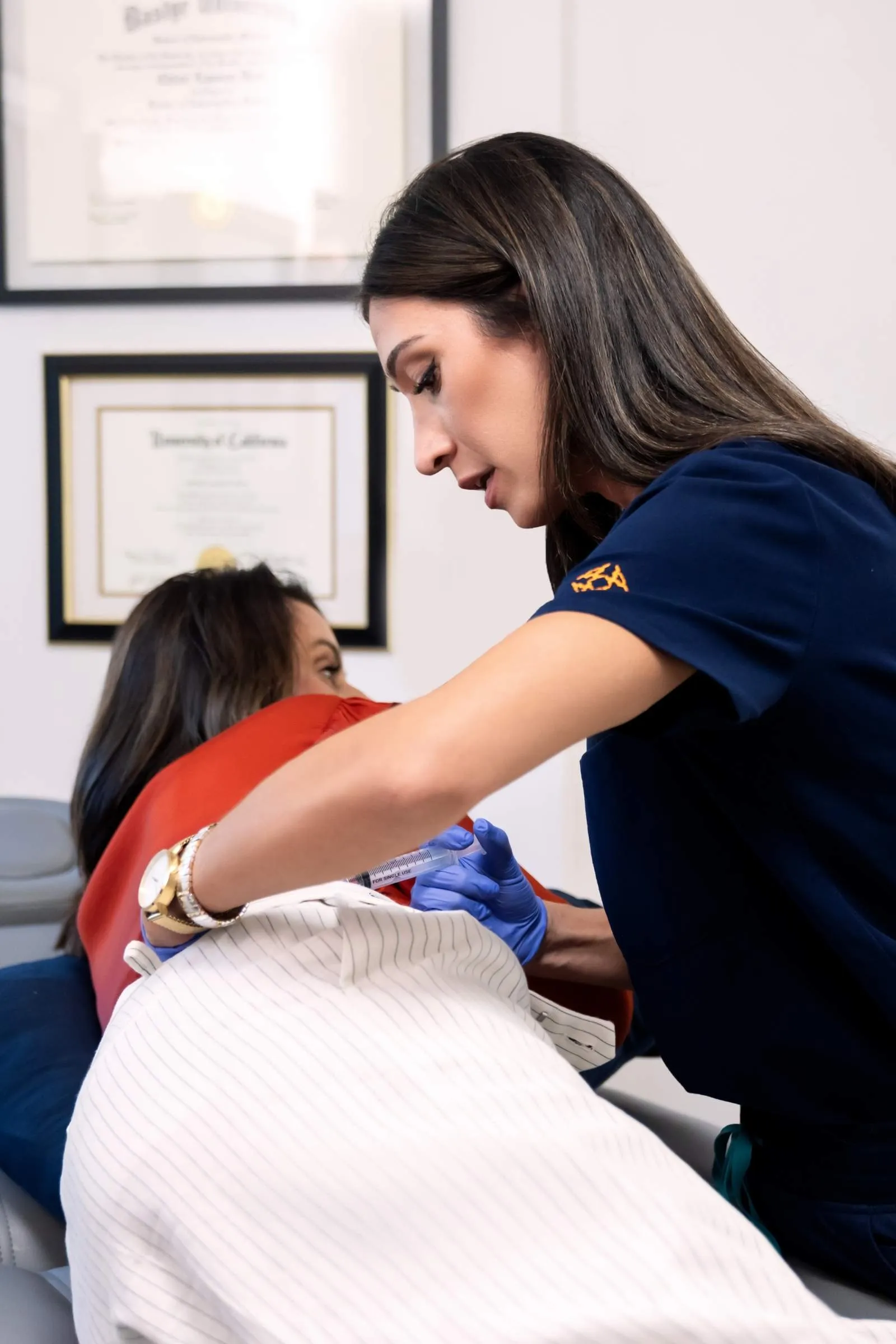 Dr Deol performing injection to Dr Young