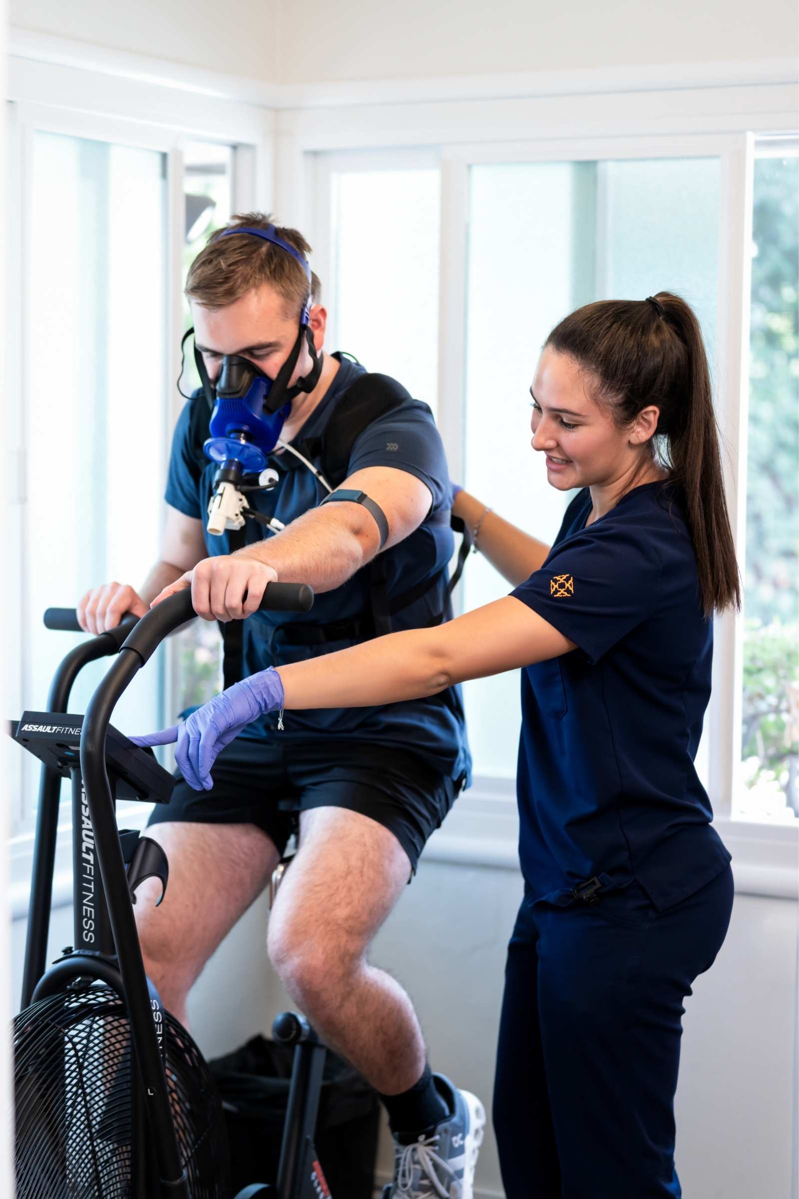 Male patient going through VO2 Max Therapy with female healthcare assistant