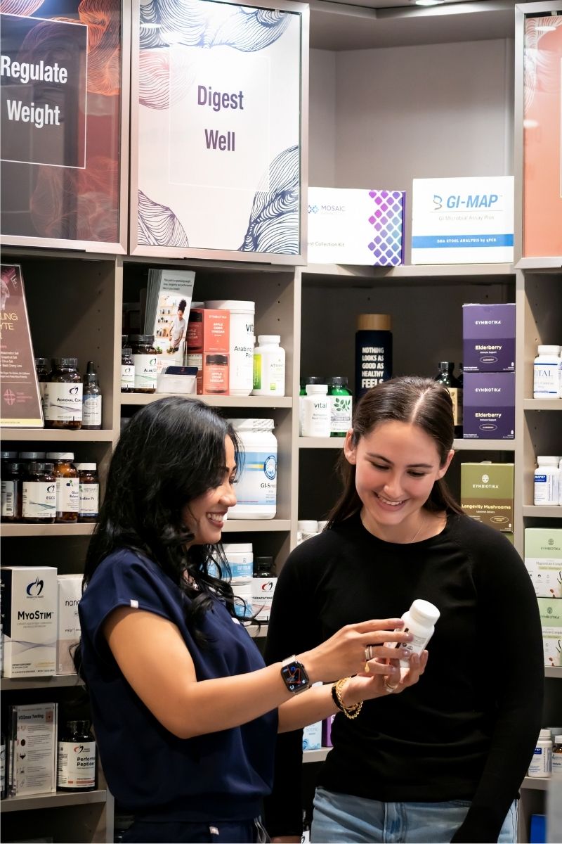 Feature photo - female healthcare assistant discussing supplements with female customer