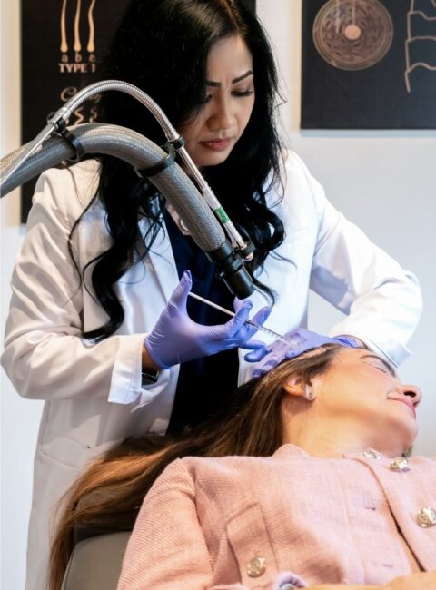 Hair Restoration - female healthcare worker performs hair restoration injection to female patient 1