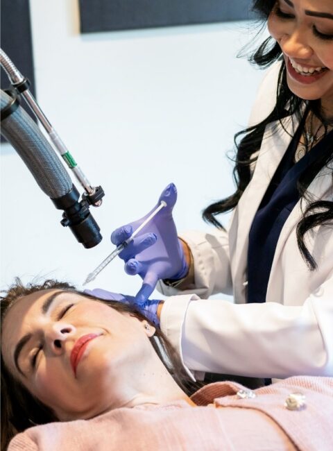 Hair Restoration - female healthcare worker performs hair restoration injection to female patient 2