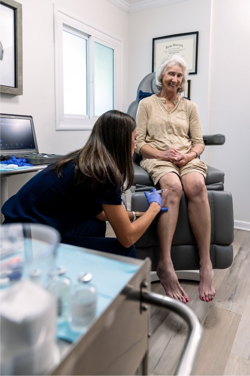 Prolozone Therapy - female patient receiving injection from female healthcare assistant 2