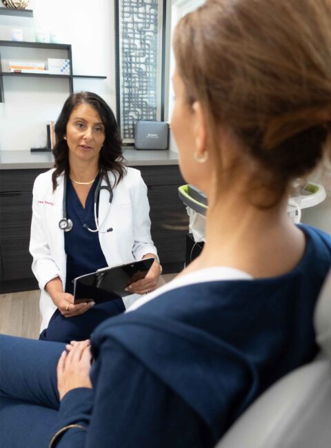 Dr Young speaking with female client