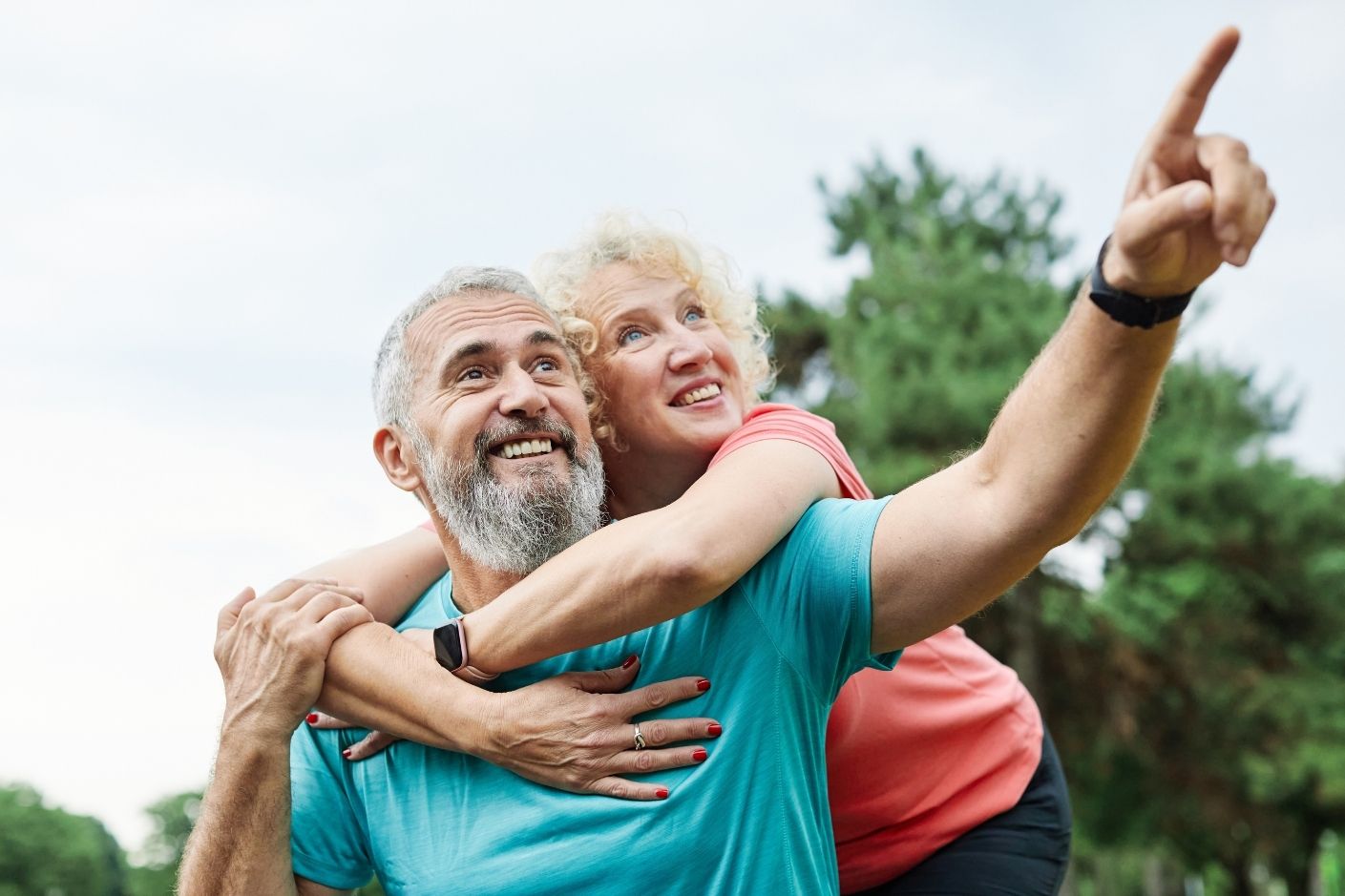 Middle aged couple smiling whilst exercising